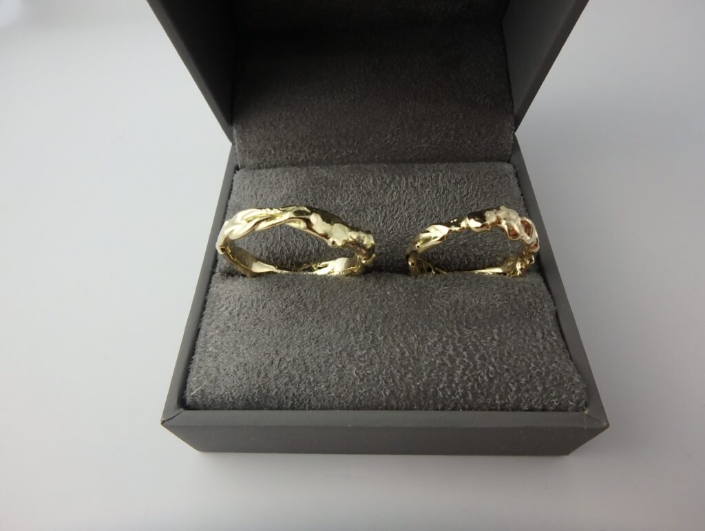 A pair of abstract, sculptural wedding rings in 18 karat gold