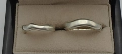 Pair of sterling silver wedding rings in natural wave shapes